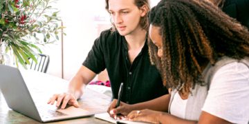 Photo by Canva Studio from Pexels: https://www.pexels.com/photo/man-working-on-laptop-while-woman-takes-notes-3153199/