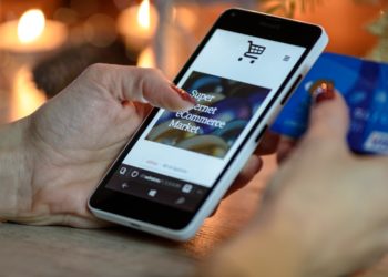 Photo by PhotoMIX Company from Pexels: https://www.pexels.com/photo/person-using-black-and-white-smartphone-and-holding-blue-card-230544/