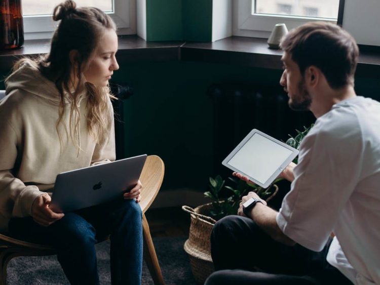 Photo by cottonbro studio from Pexels: https://www.pexels.com/photo/photo-of-couple-talking-while-holding-laptop-and-ipad-4065158/