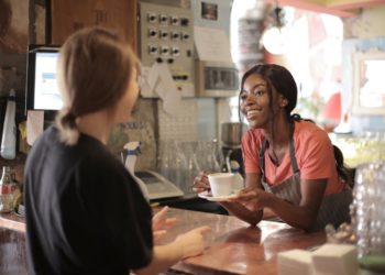 Photo by Andrea Piacquadio from Pexels: https://www.pexels.com/photo/delighted-black-female-barista-serving-coffee-in-cup-in-cafe-3796810/