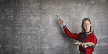 Photo by Andrea Piacquadio from Pexels: https://www.pexels.com/photo/strict-female-teacher-with-book-pointing-at-scribbled-blackboard-3771074/