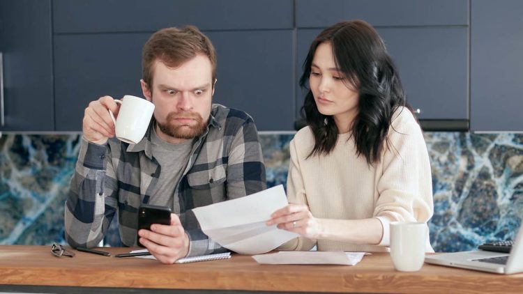 Photo by Mikhail Nilov from Pexels: https://www.pexels.com/photo/a-man-looking-at-the-paper-while-holding-a-coffee-and-phone-6963043/