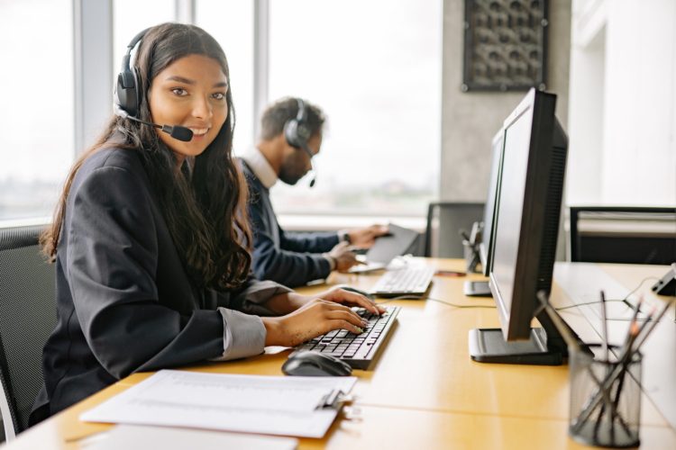 Photo by Yan Krukau from Pexels: https://www.pexels.com/photo/a-smiling-woman-working-in-a-call-center-while-looking-at-camera-8867434/