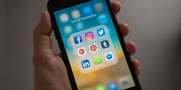Photo by Tracy Le Blanc from Pexels: https://www.pexels.com/photo/person-holding-iphone-showing-social-networks-folder-607812/
