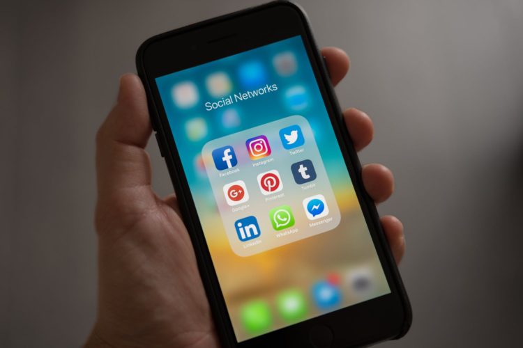 Photo by Tracy Le Blanc from Pexels: https://www.pexels.com/photo/person-holding-iphone-showing-social-networks-folder-607812/