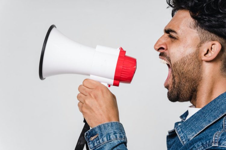 Photo by Sora Shimazaki from Pexels: https://www.pexels.com/photo/man-in-blue-denim-jacket-holding-a-megaphone-5935755/