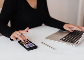 Photo by Karolina Grabowska: https://www.pexels.com/photo/crop-woman-using-smartphone-and-laptop-during-work-in-office-4467737/