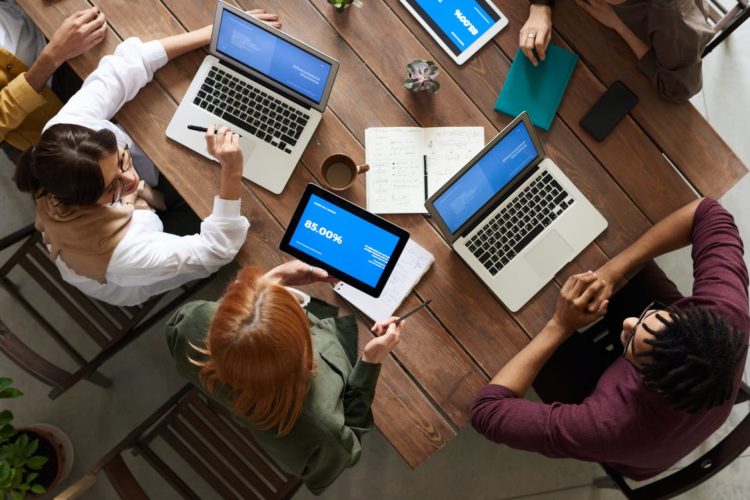 Photo by fauxels from Pexels: https://www.pexels.com/photo/top-view-photo-of-group-of-people-using-macbook-while-discussing-3182773/