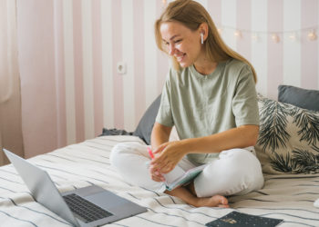 Photo by Tima Miroshnichenko from Pexels: https://www.pexels.com/photo/woman-in-green-shirt-sitting-on-bed-using-laptop-4908721/