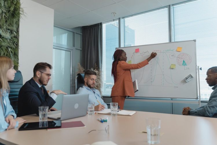 Photo by Tima Miroshnichenko from Pexels: https://www.pexels.com/photo/woman-showing-her-presentation-by-writing-on-a-white-board-5439487/