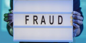 Photo by Tima Miroshnichenko from Pexels: https://www.pexels.com/photo/a-person-with-handcuffs-holding-a-sign-that-says-fraud-6266506/