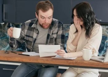 Photo by Mikhail Nilov from Pexels: https://www.pexels.com/photo/a-couple-sitting-near-the-wooden-table-while-looking-at-the-document-in-shocked-emotion-6963032/