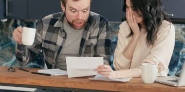 Photo by Mikhail Nilov from Pexels: https://www.pexels.com/photo/a-couple-sitting-near-the-wooden-table-while-looking-at-the-document-in-shocked-emotion-6963032/