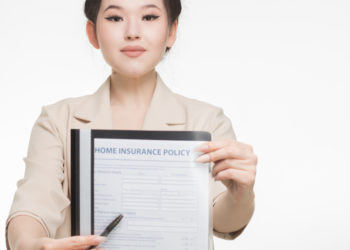 Photo by Mikhail Nilov from Pexels: https://www.pexels.com/photo/woman-in-corporate-attire-holding-a-home-insurance-policy-7736070/