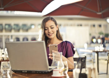 Photo by Andrea Piacquadio from Pexels: https://www.pexels.com/photo/woman-wearing-purple-shirt-holding-smartphone-white-sitting-on-chair-826349/