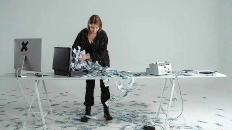 Photo by Tima Miroshnichenko from Pexels: https://www.pexels.com/photo/woman-putting-cash-money-in-a-briefcase-6266665/