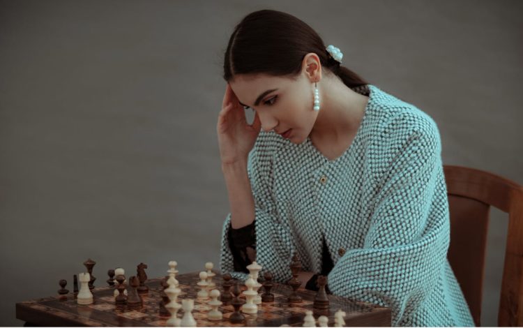 Photo by emre keshavarz from Pexels: https://www.pexels.com/photo/pensive-ethnic-woman-thinking-on-chess-move-7207270/