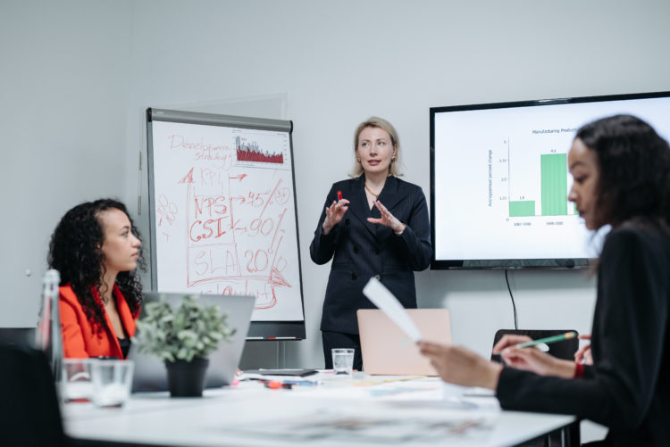 Photo by Pavel Danilyuk from Pexels: https://www.pexels.com/photo/woman-in-black-blazer-presenting-in-a-meeting-8424484/
