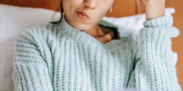 Source: https://www.pexels.com/photo/pensive-ethnic-shopper-with-debit-card-and-laptop-on-bed-6347709/