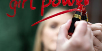 Photo by cottonbro from Pexels: https://www.pexels.com/photo/woman-in-black-shirt-holding-red-lipstick-3831881/