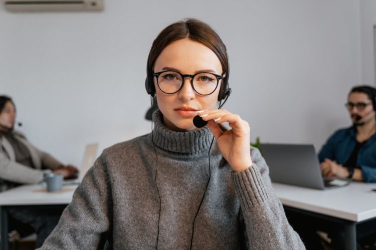 Photo by MART PRODUCTION from Pexels: https://www.pexels.com/photo/photo-of-a-woman-with-black-framed-eyeglasses-touching-a-microphone-7709207/