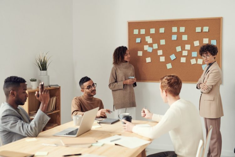 Photo by fauxels: https://www.pexels.com/photo/women-standing-beside-corkboard-3184296/