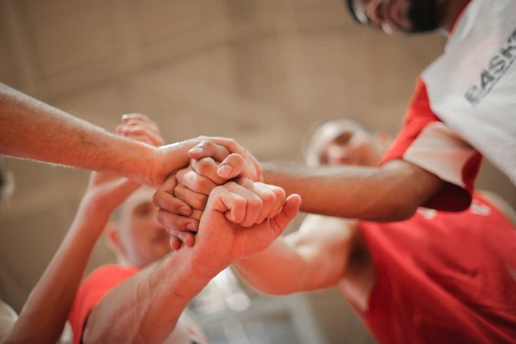 Photo by Andrea Piacquadio: https://www.pexels.com/photo/basketball-team-stacking-hands-together-3755440/