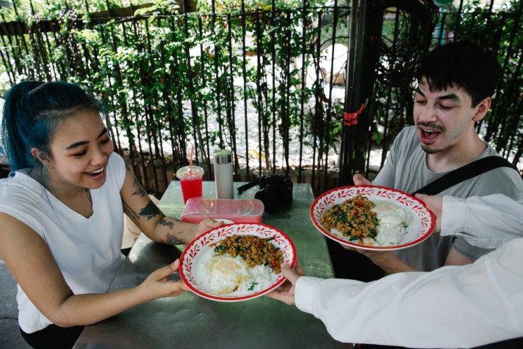 Photo by George Pak : https://www.pexels.com/photo/waiter-serving-a-fresh-meal-to-young-people-in-an-outdoor-restaurant-7969146/