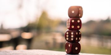 Photo by Matthias Groeneveld: https://www.pexels.com/photo/red-dice-stacked-on-table-on-terrace-4200740/