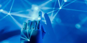 Photo by Tara Winstead: https://www.pexels.com/photo/robot-s-hand-on-a-blue-background-8386437/