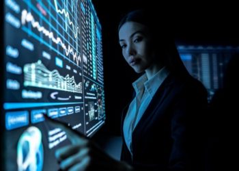 The woman works with graphics on a black monitor