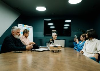 Photo by cottonbro studio: https://www.pexels.com/photo/elderly-woman-talking-to-employees-at-the-meeting-5990264/