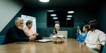 Photo by cottonbro studio: https://www.pexels.com/photo/elderly-woman-talking-to-employees-at-the-meeting-5990264/