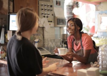 Photo by Andrea Piacquadio: https://www.pexels.com/photo/delighted-black-female-barista-serving-coffee-in-cup-in-cafe-3796810/