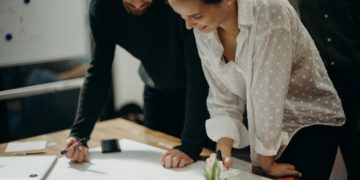 Photo by cottonbro studio: https://www.pexels.com/photo/man-and-woman-leaning-on-table-staring-at-white-board-on-top-of-table-having-a-meeting-3205570/