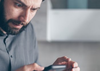 Photo by Mikhail Nilov: https://www.pexels.com/photo/man-in-gray-shirt-looking-at-a-smartphone-7534386/