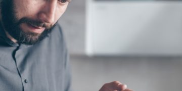 Photo by Mikhail Nilov: https://www.pexels.com/photo/man-in-gray-shirt-looking-at-a-smartphone-7534386/