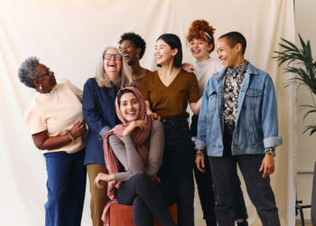 Portrait of cheerful mixed age range multi ethnic women celebrating International Women's Day
