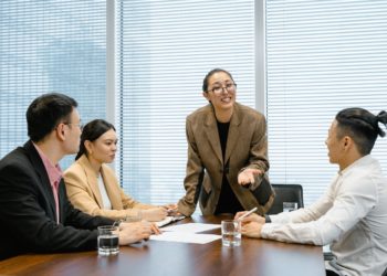 Photo by MART  PRODUCTION: https://www.pexels.com/photo/woman-wearing-eyeglasses-talking-at-the-meeting-7643872/