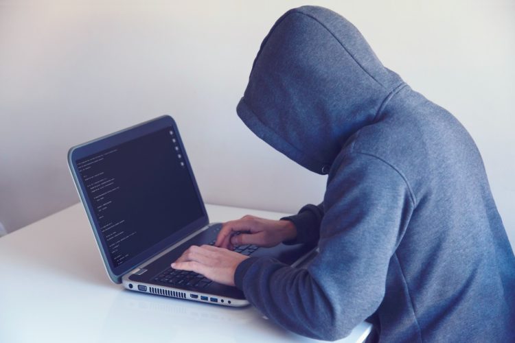 Photo by Nikita Belokhonov: https://www.pexels.com/photo/anonymous-hacker-with-on-laptop-in-white-room-5829726/