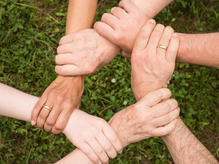 Photo by Pixabay: https://www.pexels.com/photo/group-of-people-holding-arms-461049/