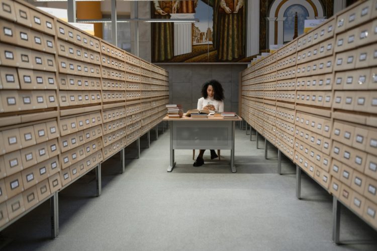 Photo by Tima Miroshnichenko: https://www.pexels.com/photo/a-girl-sitting-in-front-of-a-table-between-database-wooden-drawer-6549629/