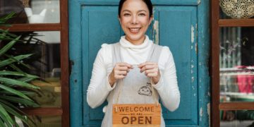 Photo by Ketut Subiyanto: https://www.pexels.com/photo/ethnic-female-cafe-owner-showing-welcome-we-are-open-inscription-4473398/