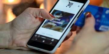 Photo by PhotoMIX Company: https://www.pexels.com/photo/person-using-black-and-white-smartphone-and-holding-blue-card-230544/