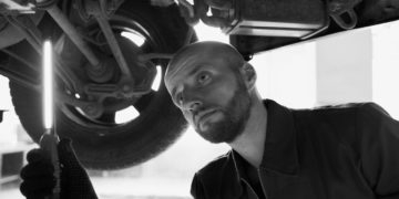 Photo by Artem Podrez: https://www.pexels.com/photo/black-and-white-photo-of-a-mechanic-under-a-car-8985605/