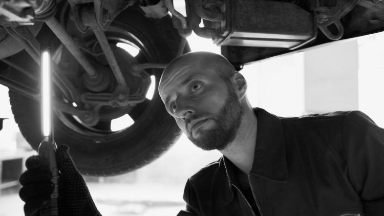 Photo by Artem Podrez: https://www.pexels.com/photo/black-and-white-photo-of-a-mechanic-under-a-car-8985605/