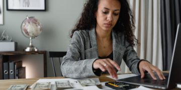 Photo by Tima Miroshnichenko from Pexels: https://www.pexels.com/photo/a-woman-in-plaid-blazer-using-her-laptop-and-mobile-phone-6693656/