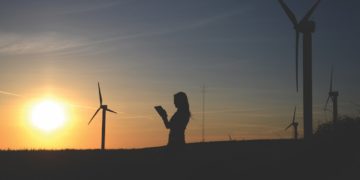 Photo by Richard Dacker: https://www.pexels.com/photo/silhouette-of-woman-holding-book-near-windmills-636335/