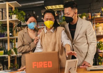 Photo by ANTONI SHKRABA production: https://www.pexels.com/photo/man-in-brown-coat-holding-brown-cardboard-box-8279209/
