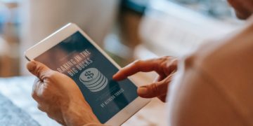 Photo by Gary  Barnes: https://www.pexels.com/photo/anonymous-man-working-remotely-on-tablet-during-breakfast-with-wife-in-kitchen-6248545/